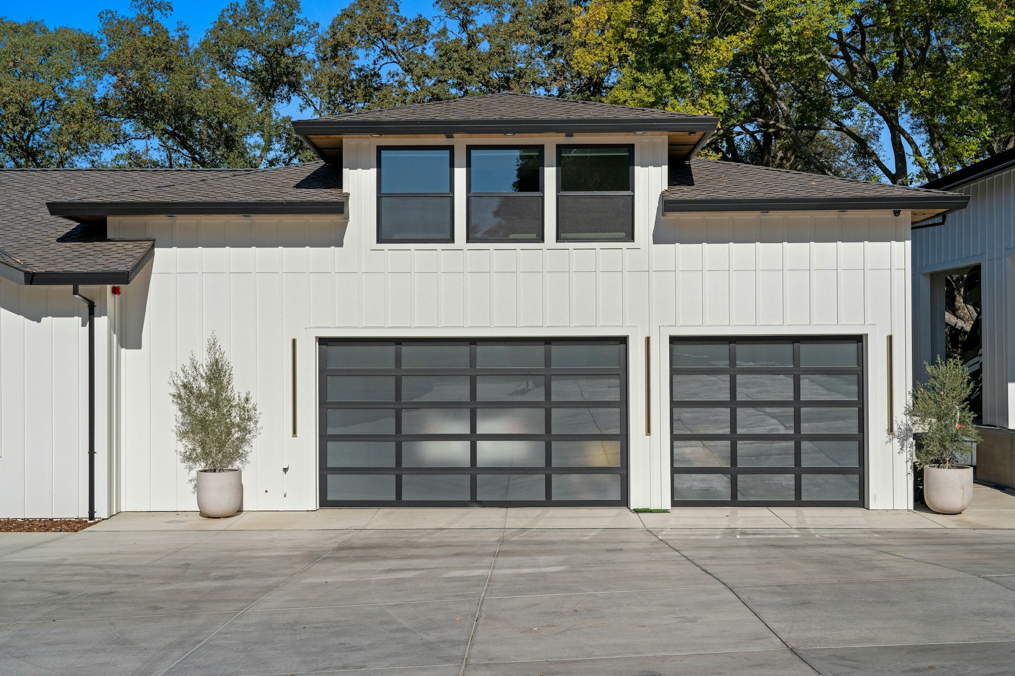 Modern home with two glass-panel garage doors